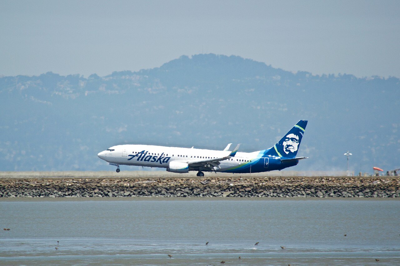 Alaska 737 reported a dirty-sock odor after takeoff from Portland causing flight attendant headache