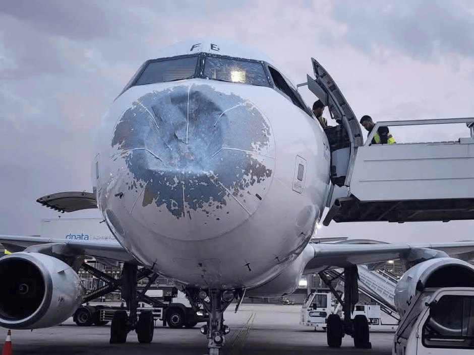 Passenger jet's nose caves in & windscreen cracks after flying through storm but is able to finish journey
